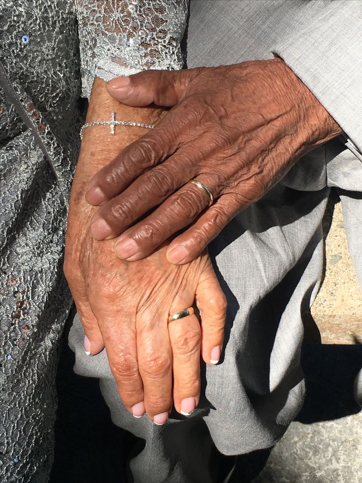 Couple's hands with wedding rings